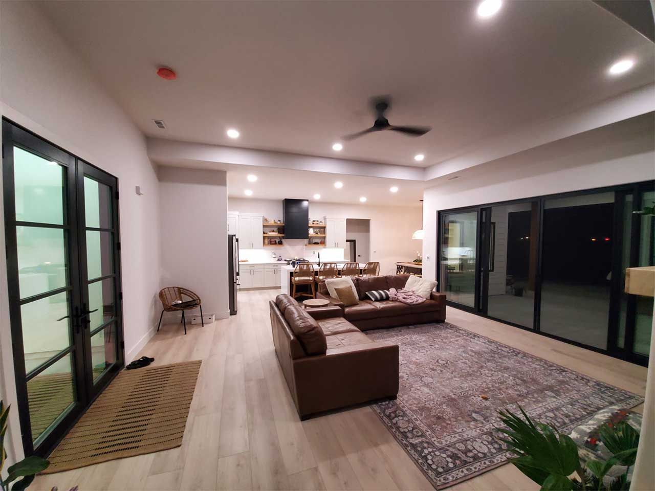 A living room with a brown couch and a rug