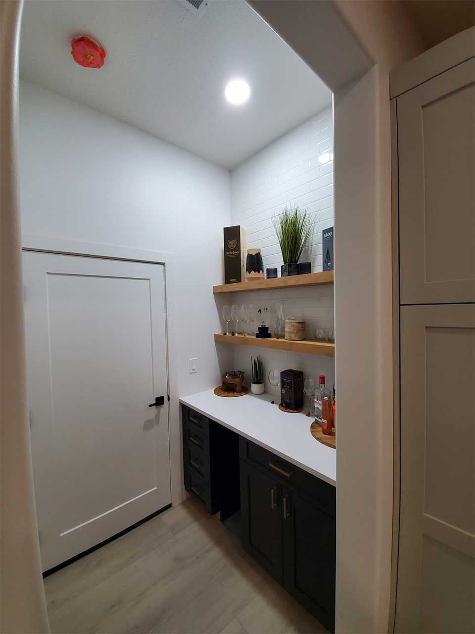 A room with a desk and shelves in it