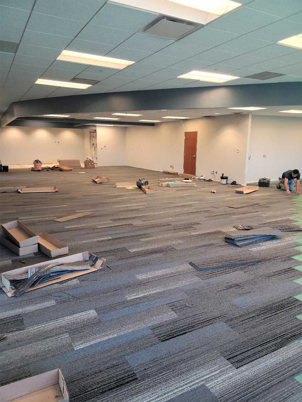 A large empty room with a lot of boxes on the floor.