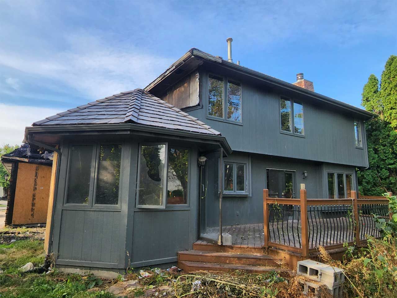 A large house with a roof that is covered in shingles.