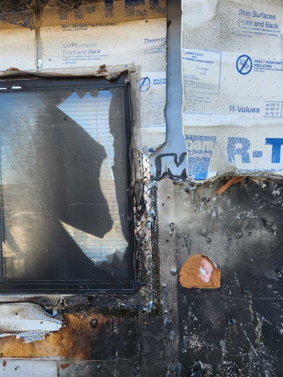 A wall with a window and a sign that says r-t