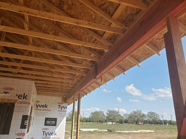 The roof of a building is being built with tyvek insulation.