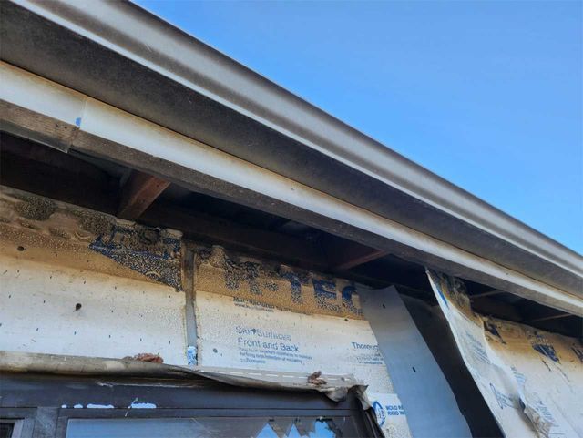 A roof of a building with a blue sky in the background