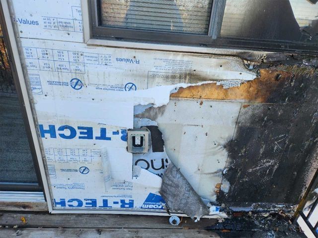 A damaged door with a r-tech sticker on it