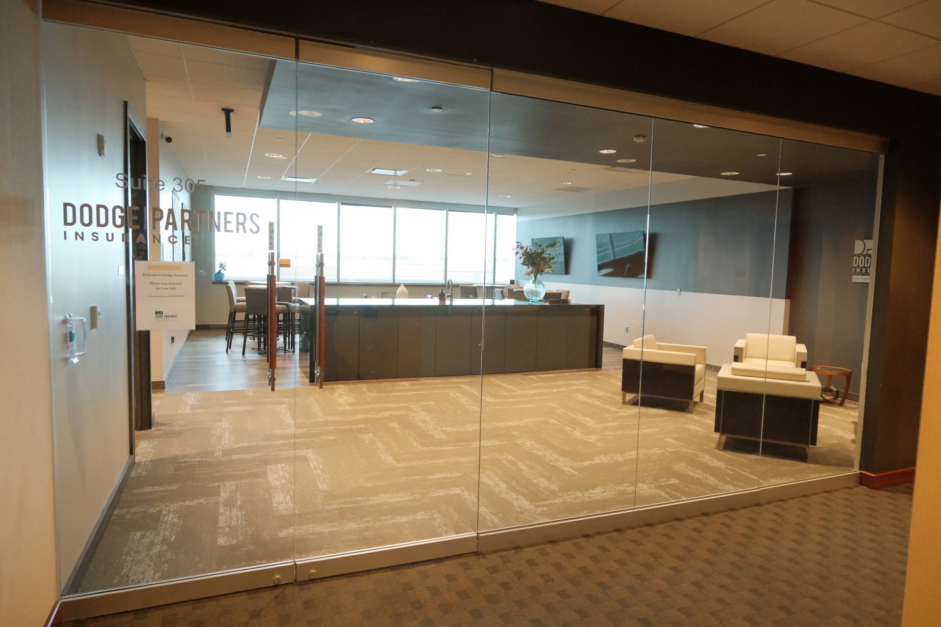 A large room with a lot of windows and a glass door.