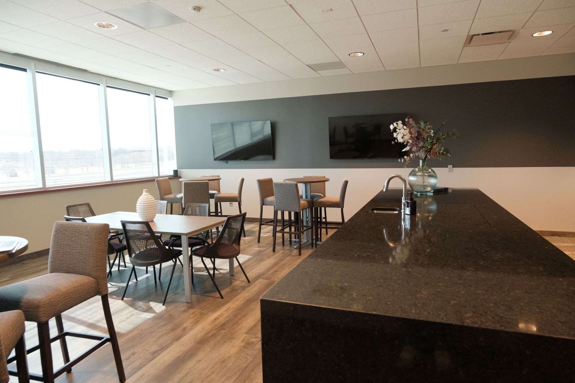 A room with tables and chairs and a large counter