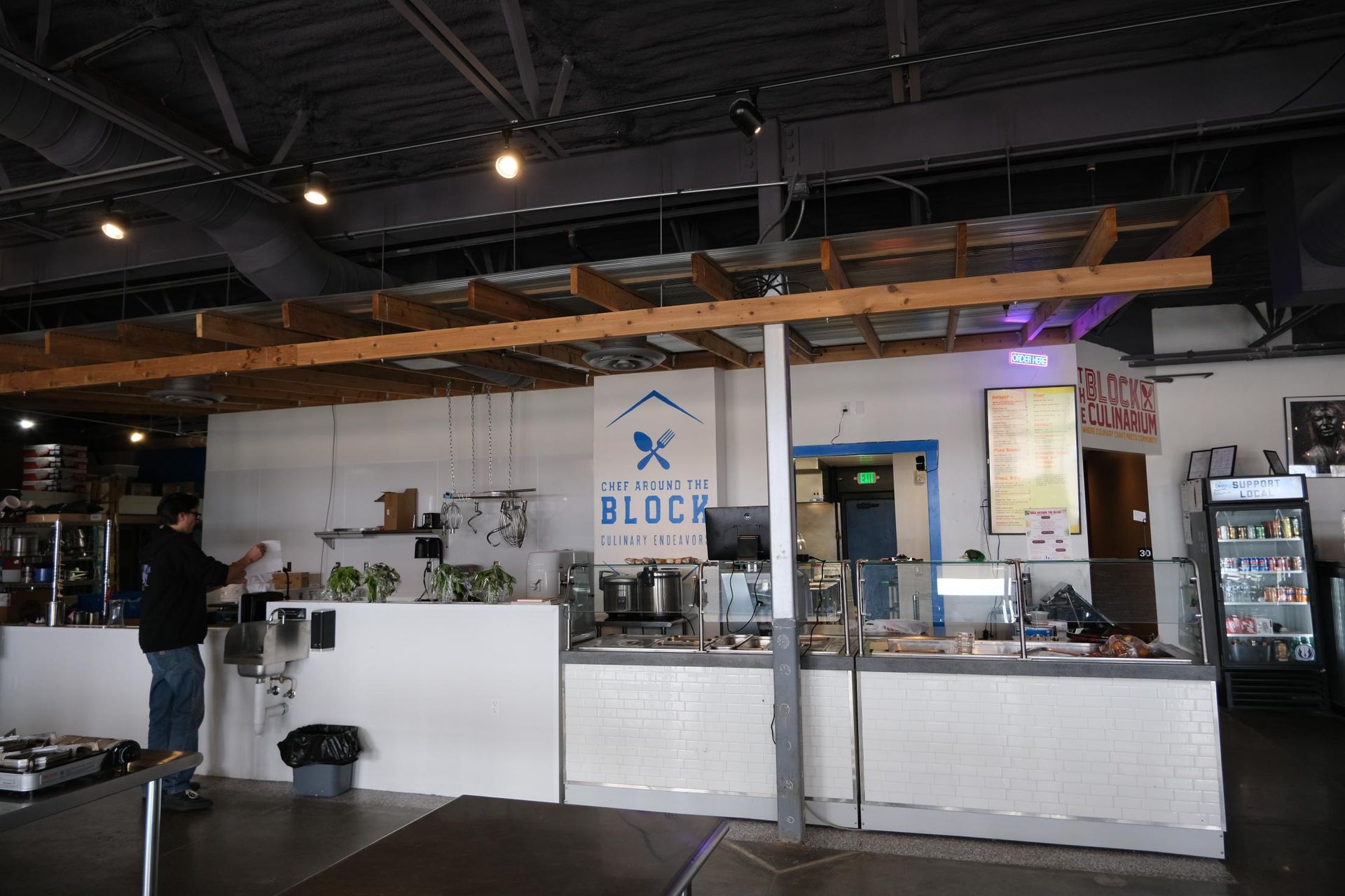 A view of a counter-service restaurant featuring a wooden ceiling beam, a 