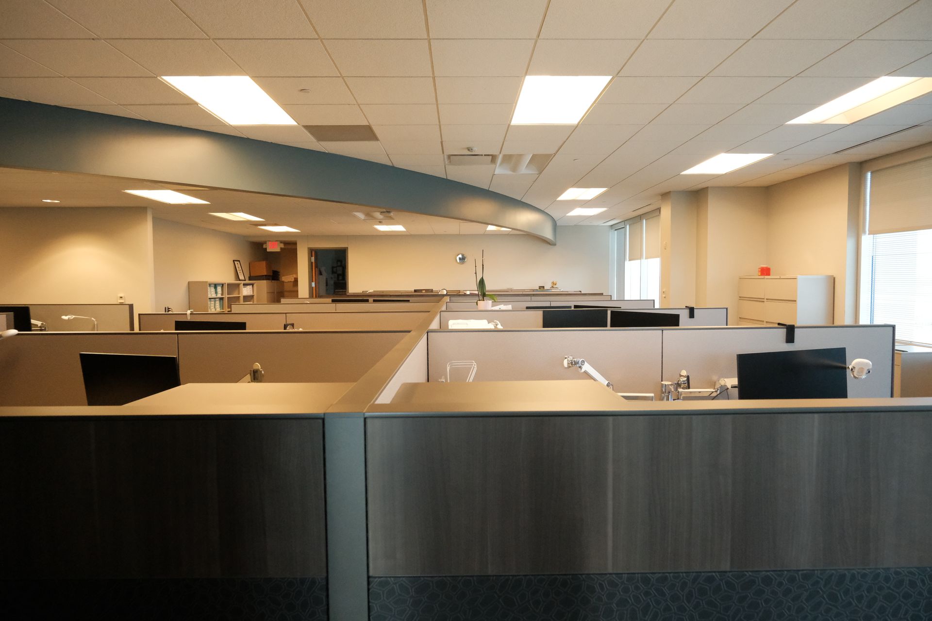 A large empty office with cubicles and desks