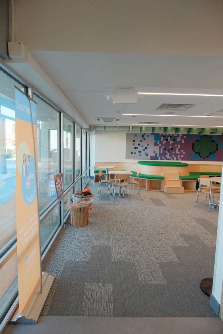 A large room with a lot of windows and tables and chairs