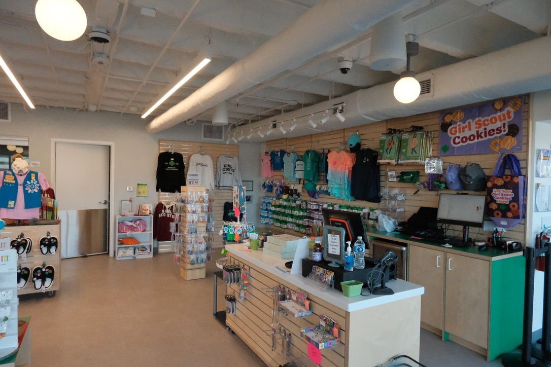 A store filled with lots of clothes and a counter.