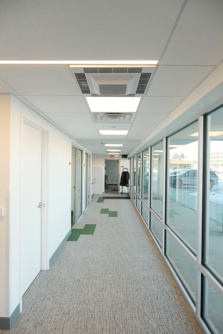 A long hallway with a lot of windows and doors