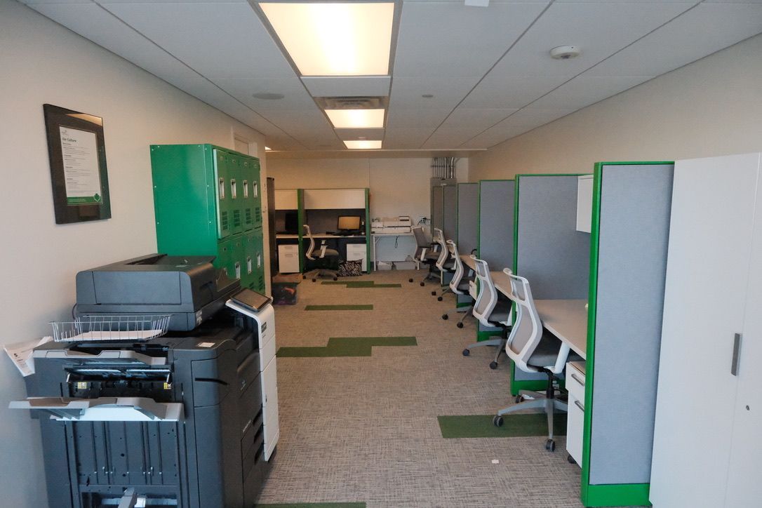 An office with cubicles and a printer in the middle