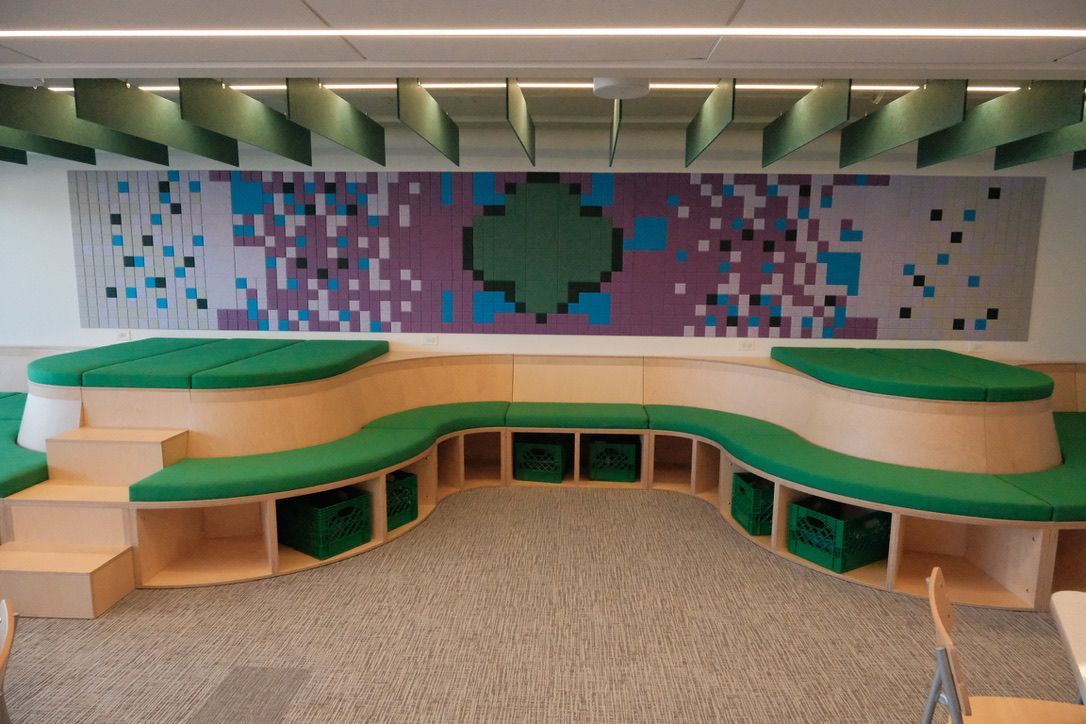 A room with a couch and a painting on the wall