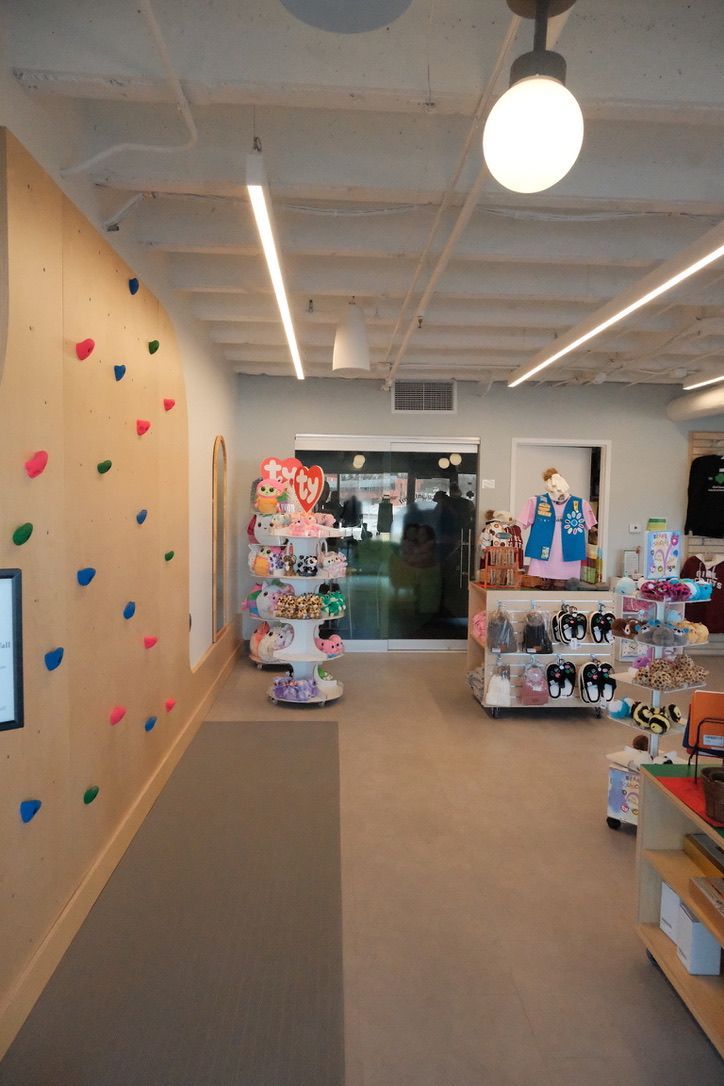 There is a climbing wall in the middle of the room.