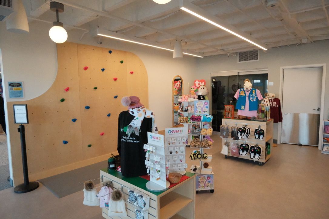 A room with a climbing wall and a table with toys on it.