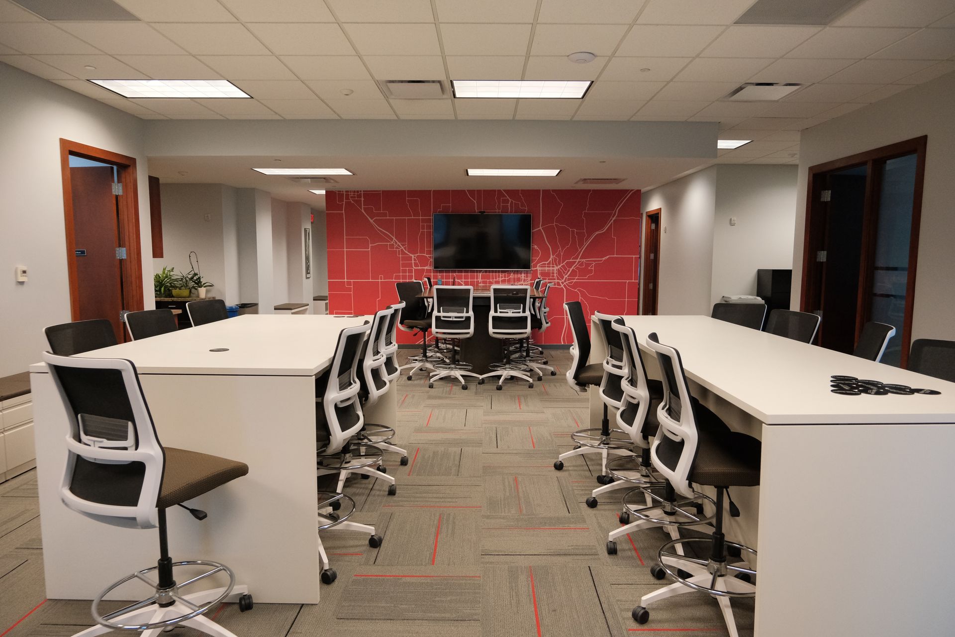 A large conference room with a long table and chairs.