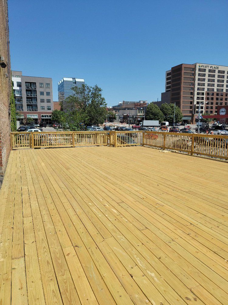 A large wooden deck with a city in the background