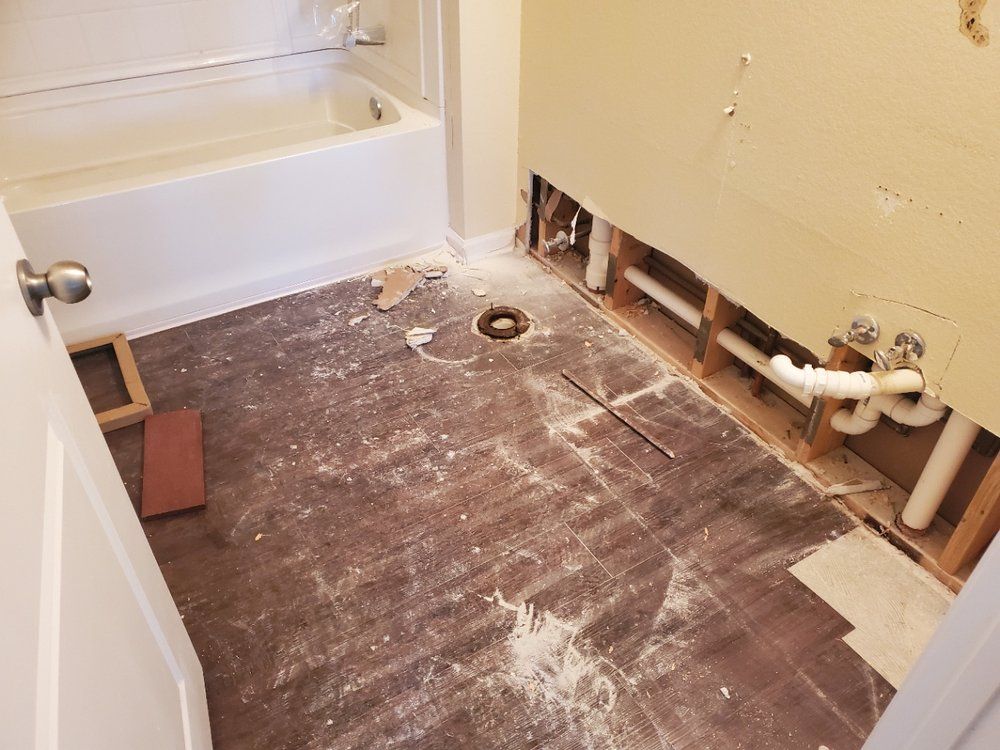 A bathroom under construction with a bathtub and sink.