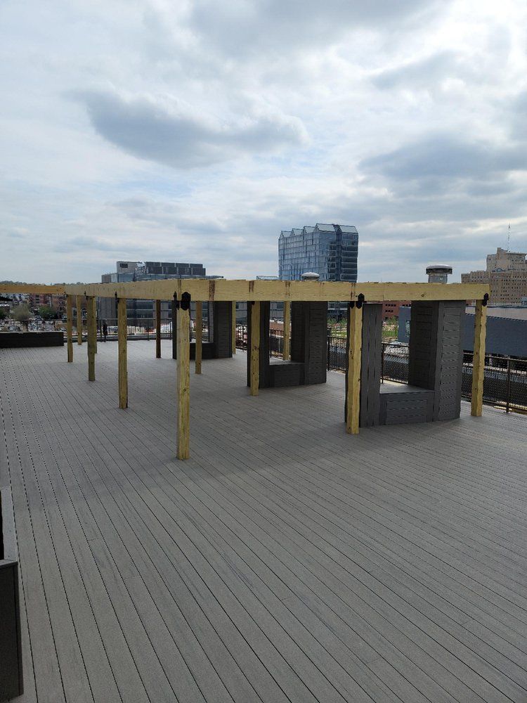 A wooden deck with a building in the background