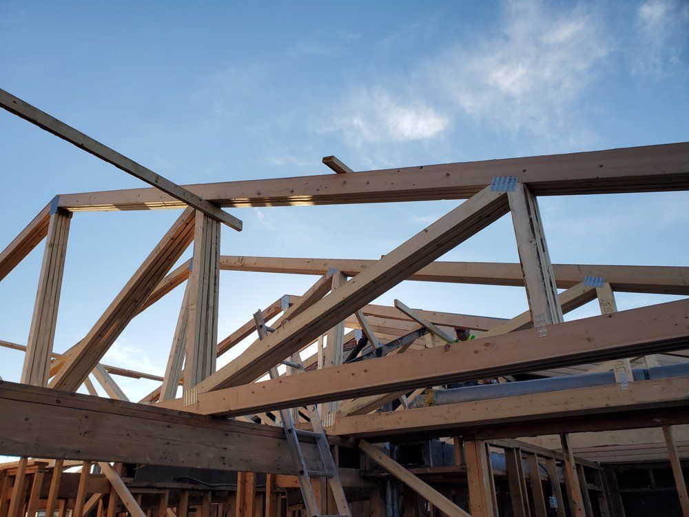 A building under construction with a blue sky in the background.