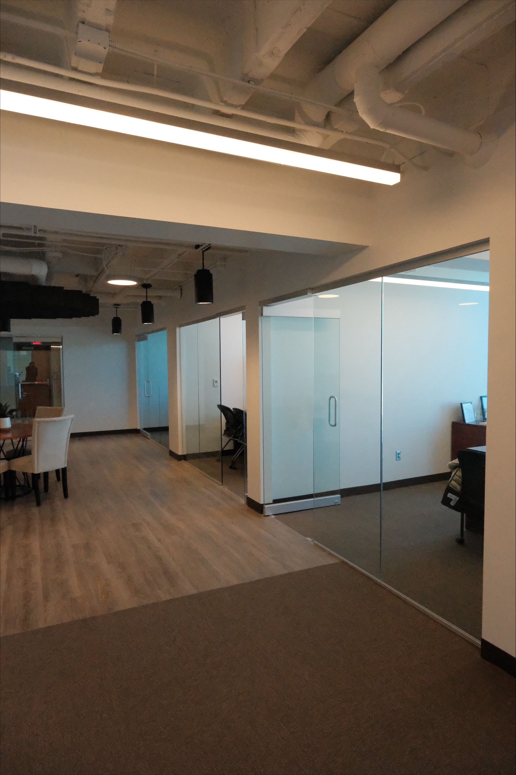 A large room with a lot of glass doors and chairs