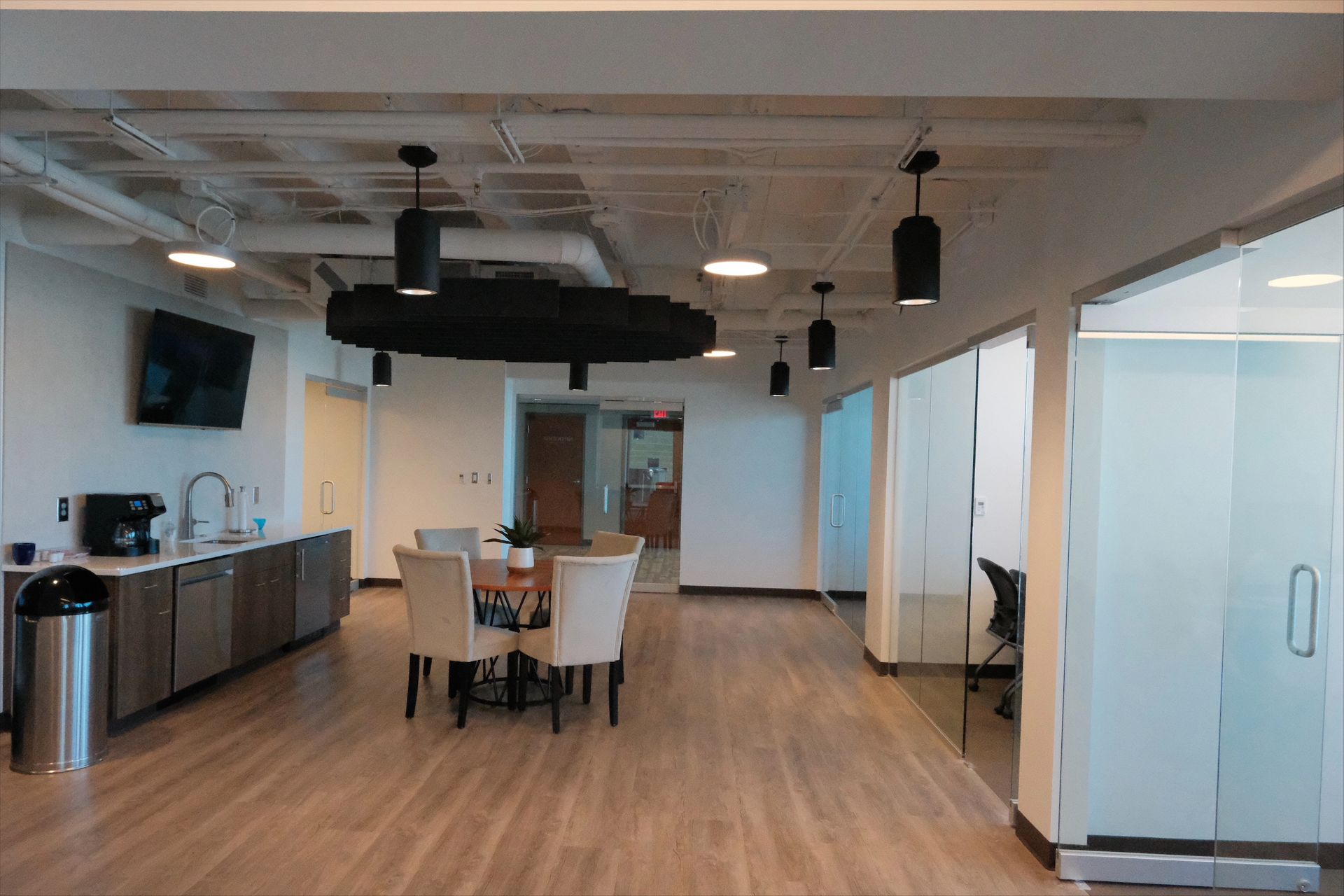 There is a table and chairs in the middle of the room.