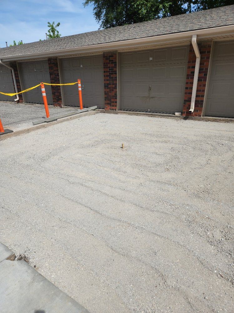 A row of garage doors are lined up in a parking lot