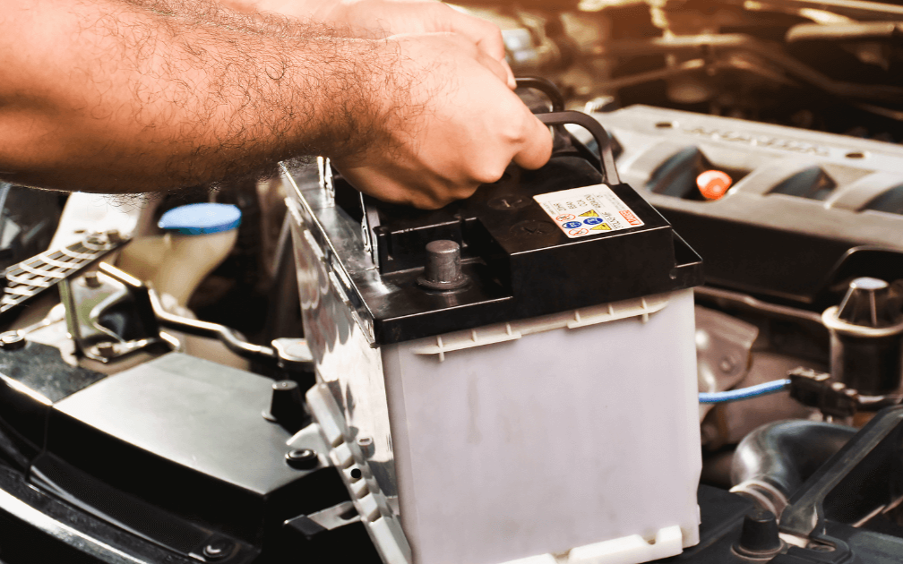 a mechanic doing a battery replacement