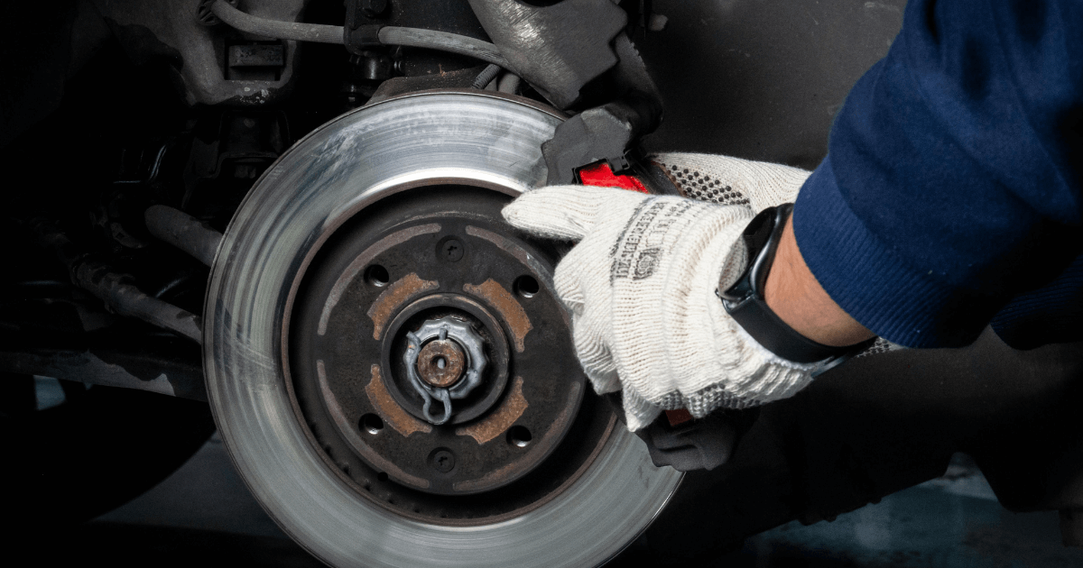 a mechanic repairing a vehicle outdoors