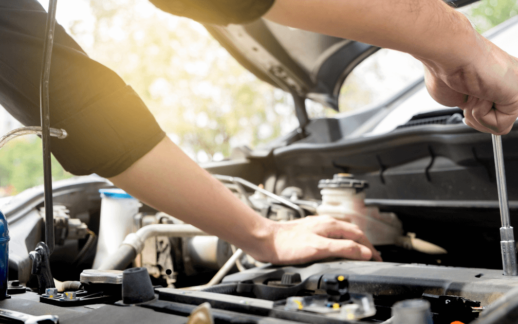 a mechanic repairing a vehicle outdoors