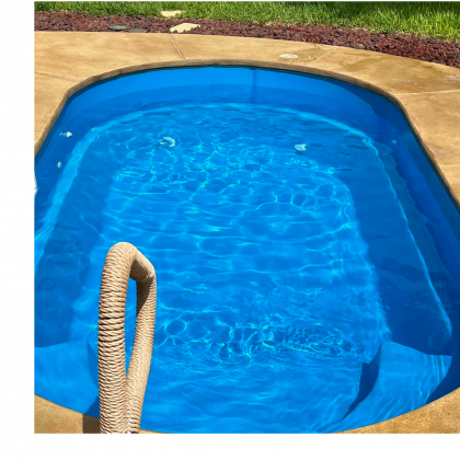 A blue swimming pool with a rope leading to it