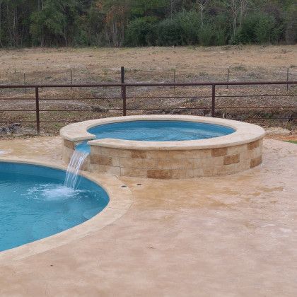 There is a waterfall in the middle of the pool.