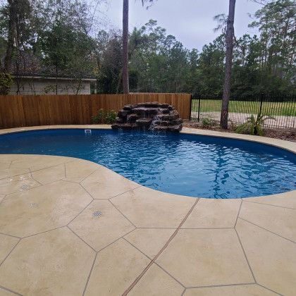 There is a waterfall in the middle of the pool.
