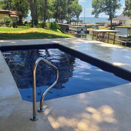 A large swimming pool with a staircase leading to it.
