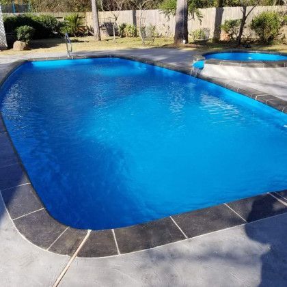 A large blue swimming pool with two smaller pools in the background.