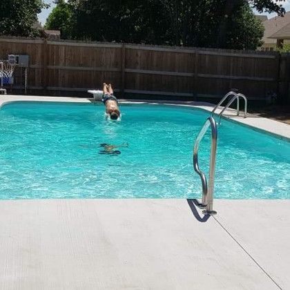 A man is diving into a swimming pool.