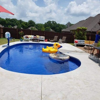 A large swimming pool with a duck float in it