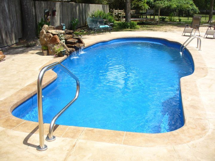 A large blue swimming pool with stairs leading to it