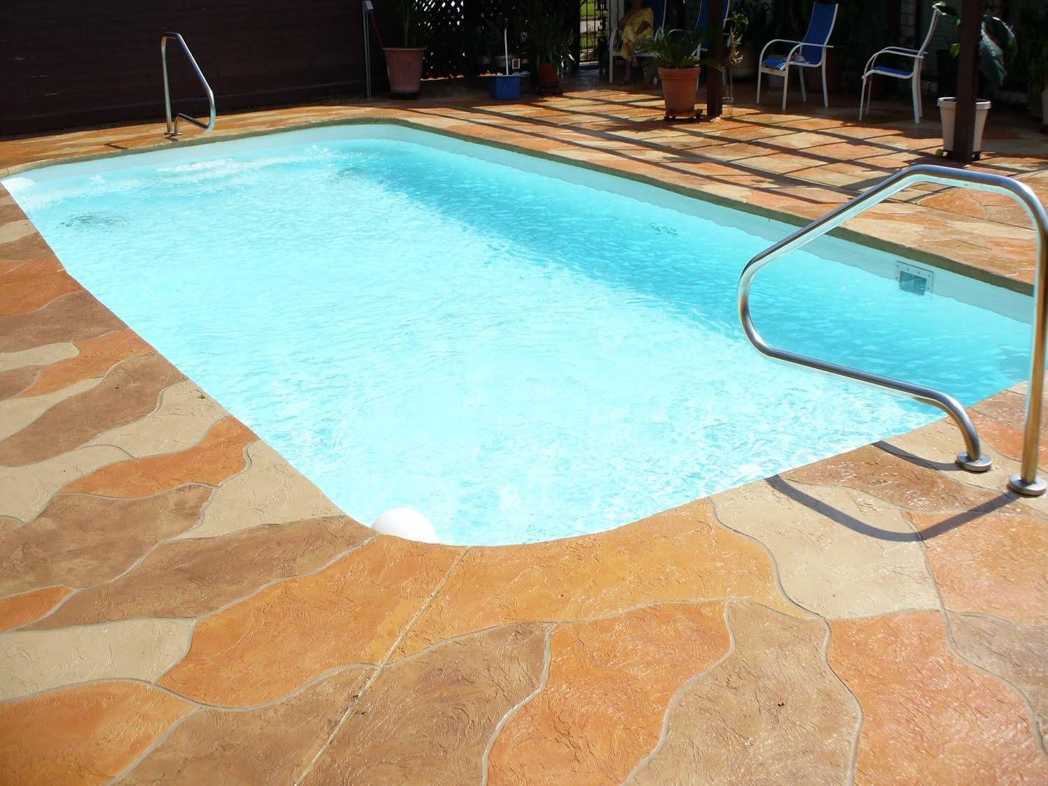 A large swimming pool with a staircase leading to it