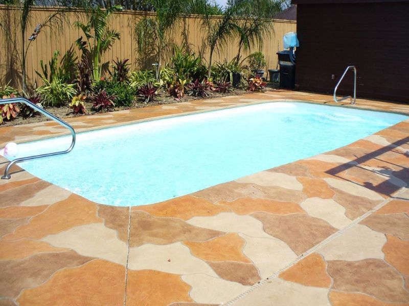 A large swimming pool with a fence in the background