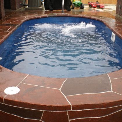 A swimming pool with a tractor in the background