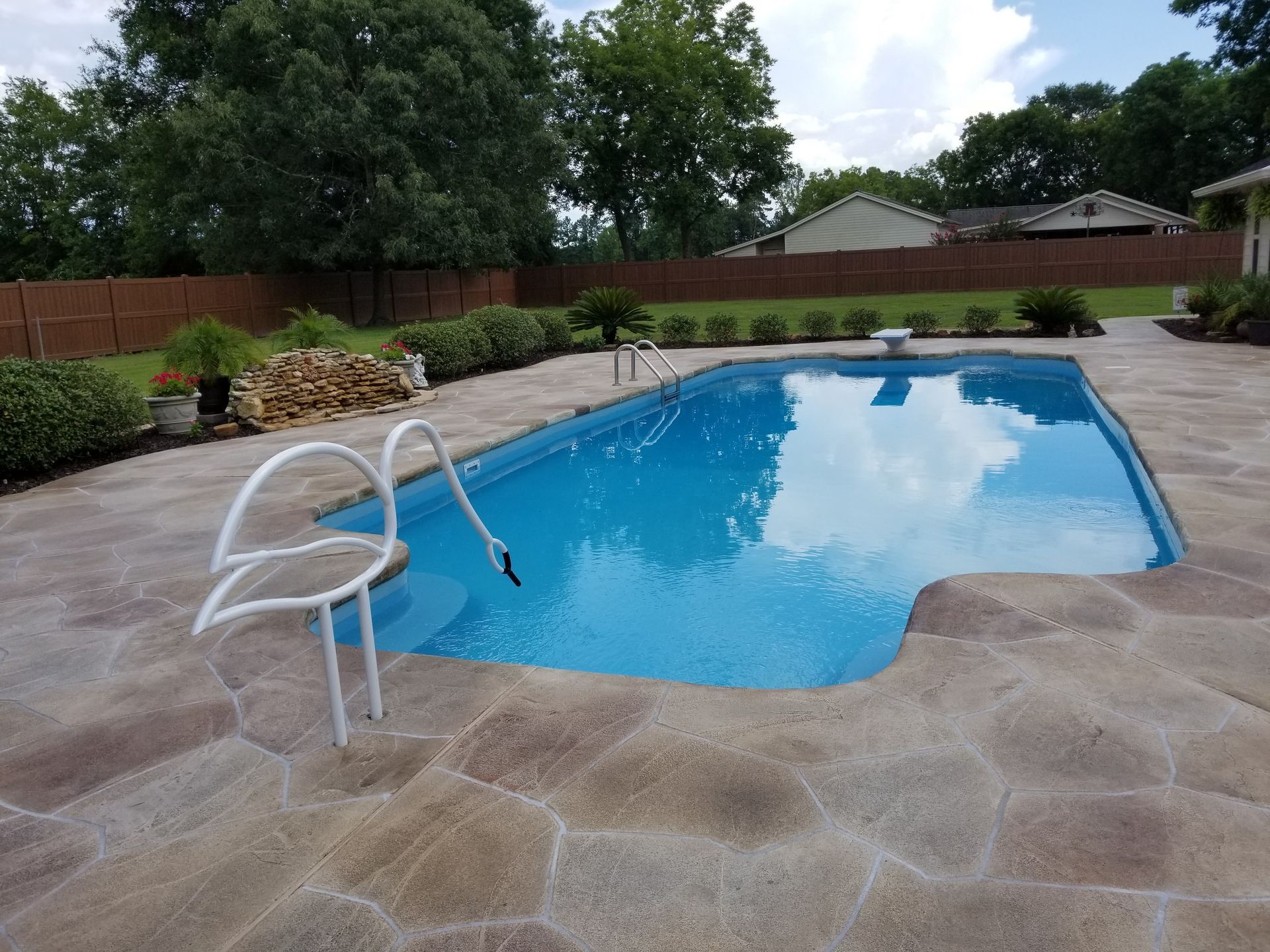 A large swimming pool with a ladder leading to it