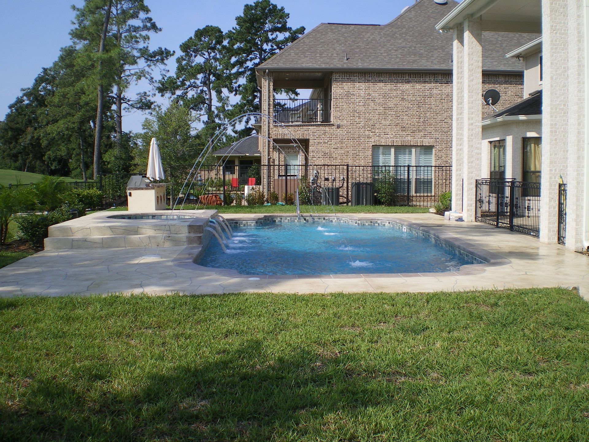 A large house with a large swimming pool in front of it