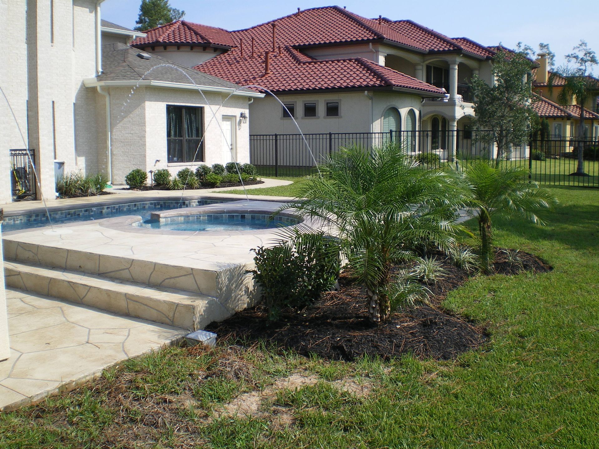 A large house with a swimming pool in front of it