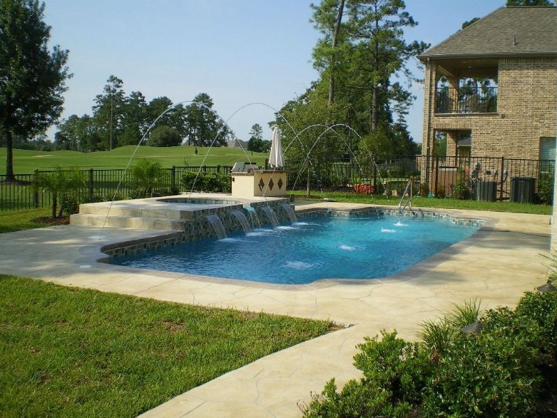 A large swimming pool in the backyard of a house
