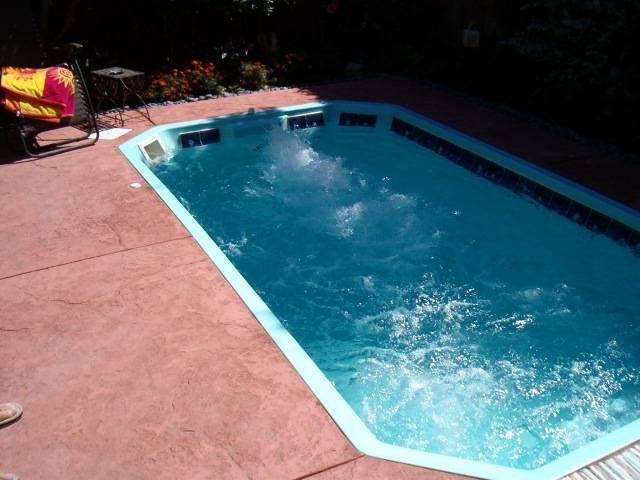 A swimming pool is filled with blue water
