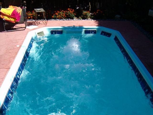 A large swimming pool is filled with blue water