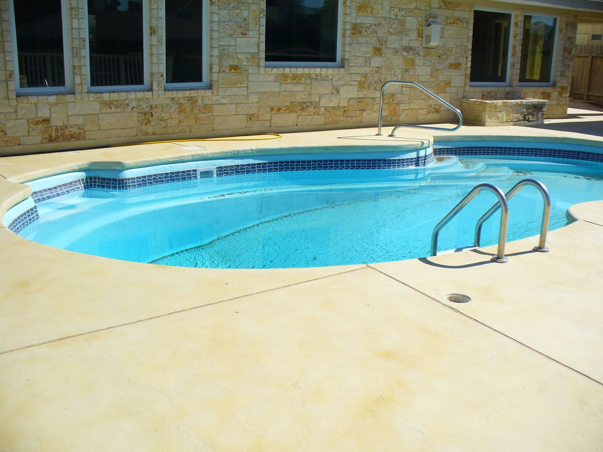 A large swimming pool with stairs leading to it
