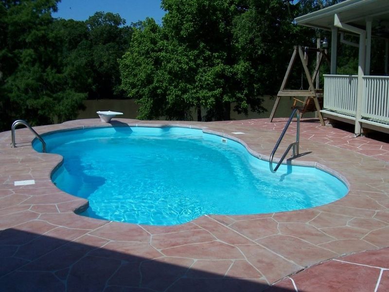 A large swimming pool with stairs leading to it