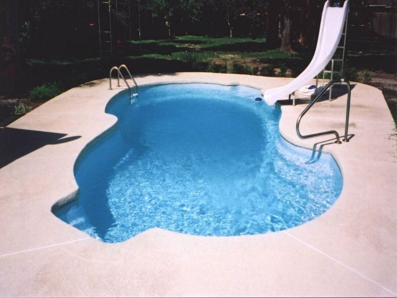 A swimming pool with a slide attached to it